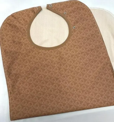 CLOTHING PROTECTOR - CHAMPAGNE BUBBLES NON-QUILTED WITH 3 ADJ. SNAPS & TAN VINYL 